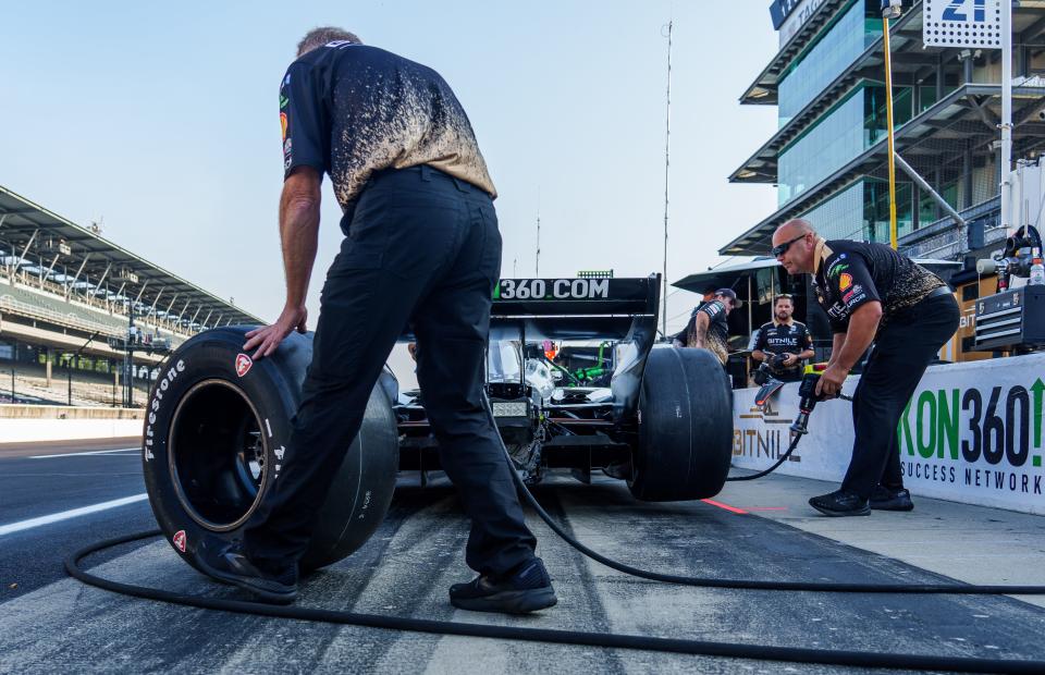 The crew of Ed Carpenter Racing driver Rinus VeeKay (21) prepares his car Friday, Aug. 11, 2023, ahead of practice for the Gallagher Grand Prix at Indianapolis Motor Speedway. 