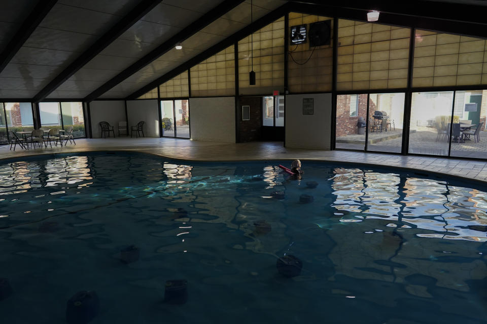 An Amish woman from Ohio floats with a pool noodle among BioHealing generators at the Tesla Wellness Hotel and MedBed Center on Wednesday, Nov. 15, 2023, in Butler, Pa. She visits the center twice a month. (AP Photo/Carolyn Kaster)