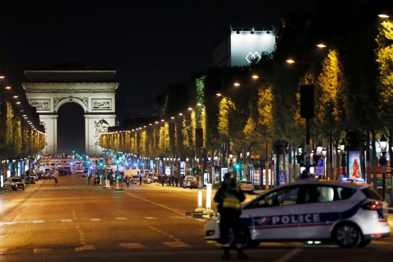 Police block access to the Champs Elysees in Paris after a shooting left one officer dead and two wounded