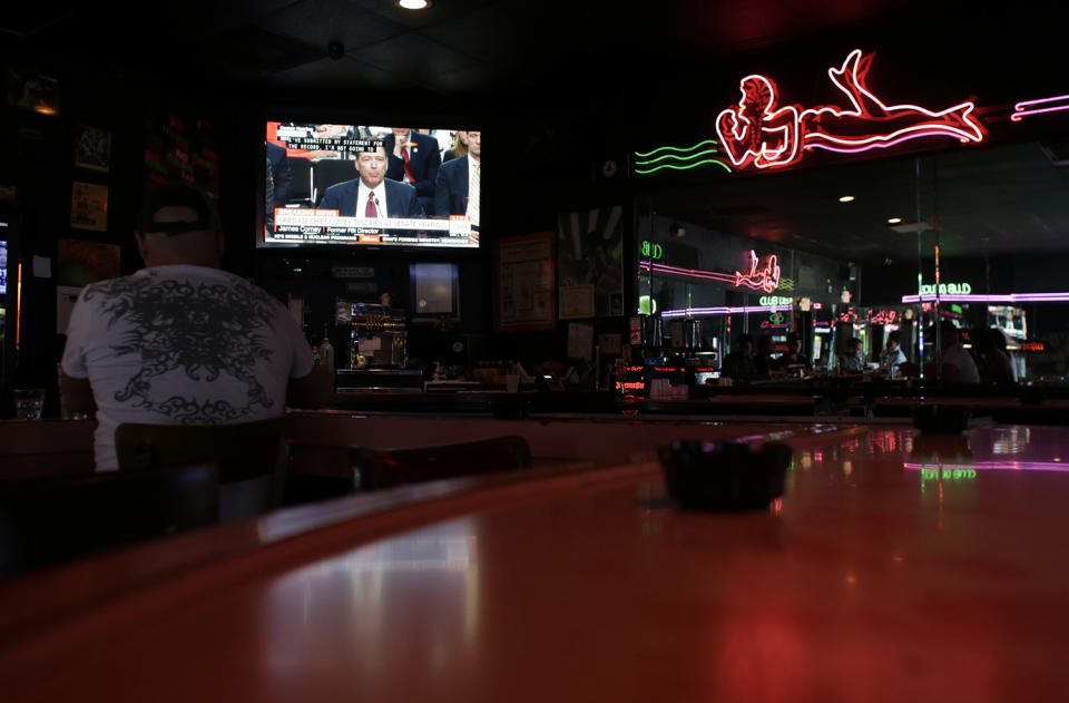 <p>Patrons at Mac’s Club Deuce watch testimony by former FBI director James Comey before the Senate Intelligence Committee, June 8, 2017, in Miami Beach, Fla. (Lynne Sladky/AP) </p>