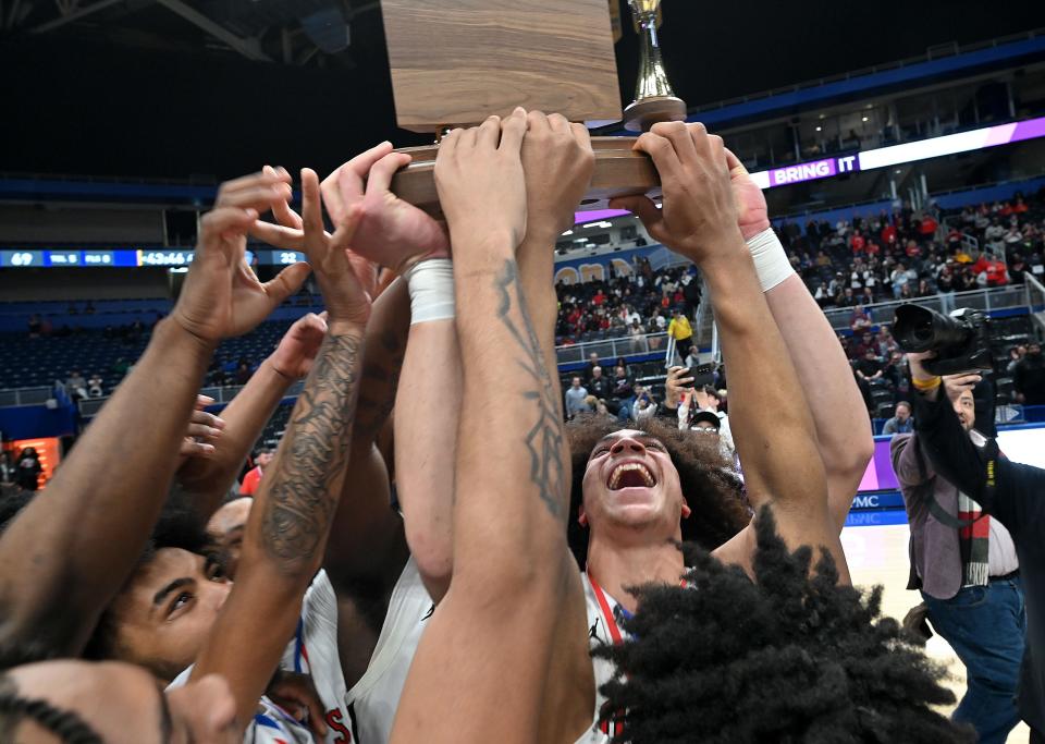 The Aliquippa Quips celebrate their Class 2A WPIAL championship win over Greensburg Central Catholic, Saturday at the Petersen Events Center in Pittsburgh.