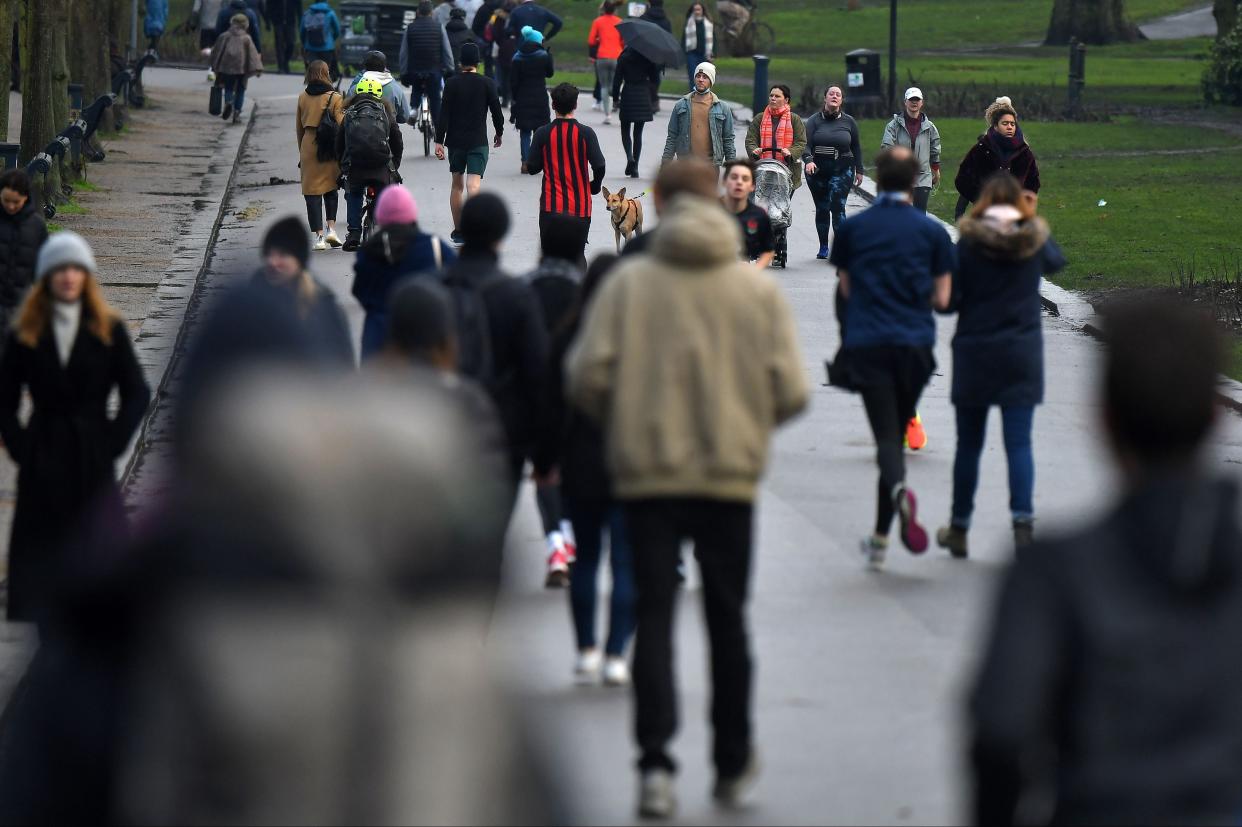 <p>People walk in Victoria Park in east London on Saturday, as life in England continues under lockdown</p> (AFP via Getty Images)