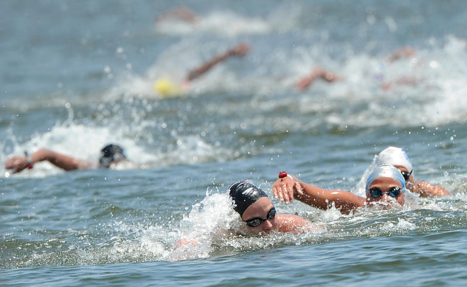 Gold medal winner Britain's Keri-Anne Payne (C-front) is chased by silver medal winner Italy's Martina Grimaldi (R) during the women's 10km open water swimming event of the FINA World Championships in Shanghai on July 19, 2011. Payne, who took silver at the 2008 Beijing Games, swam the women's 10km open water in 2hr 1min 58.1secs, winning ahead of Italy's Martina Grimaldi and ramping up hopes for London 2012.  AFP PHOTO / PHILIPPE LOPEZ (Photo credit should read PHILIPPE LOPEZ/AFP/Getty Images)