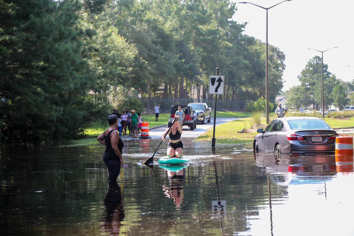 A resident paddles into flood waters on Bradley Boulevard on Saturday, August 10, 2024 as flooding from the Ogeechee River continued to impact the Bradley Point neighborhood in Savannah.