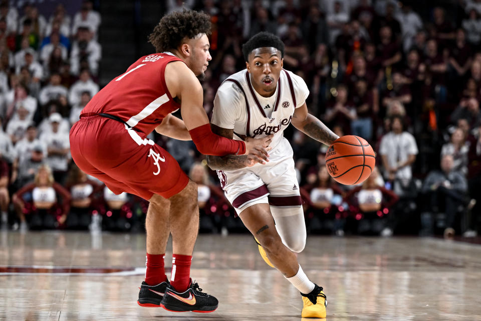 Mar 4, 2023; College Station, Texas; Texas A&M Aggies guard Wade Taylor IV (4) controls the ball as Alabama Crimson Tide guard Mark Sears (1) defends during the second half at Reed Arena. Maria Lysaker-USA TODAY Sports