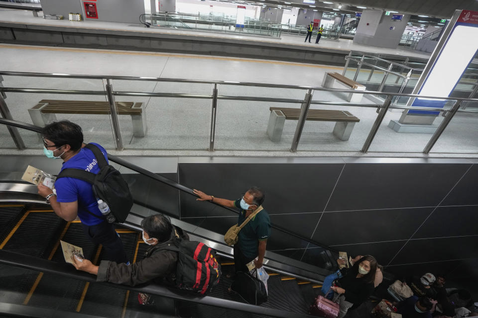 Passengers ride an escalator to the platform top board an outbound train at the Krung Thep Aphiwat Central Terminal in Bangkok, Thailand, Thursday, Jan. 19, 2023. Thailand ushered in a new age of train travel on Thursday when what’s said to be Southeast Asia’s biggest railway station officially began operations. (AP Photo/Sakchai Lalit)