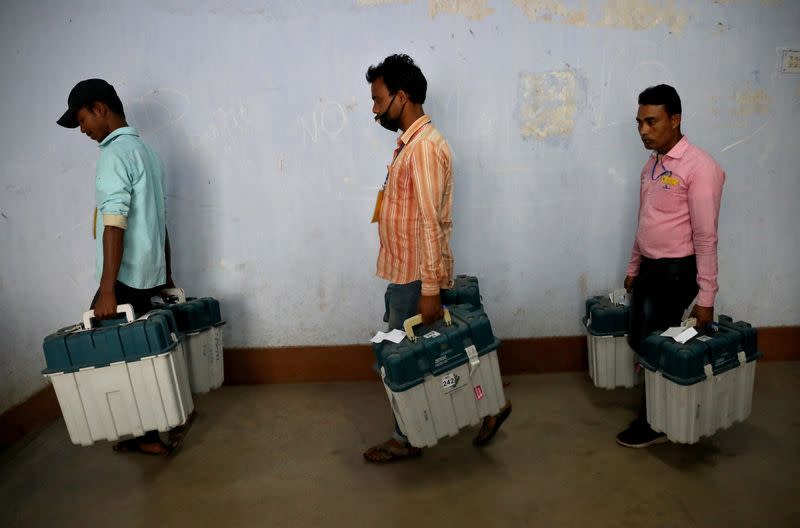 Election workers carry Voter Verifiable Paper Audit Trail (VVPAT) machines, in Purulia