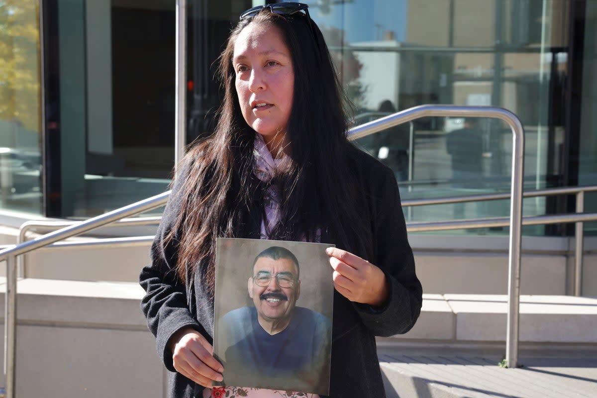 A photo of Eduardo Uvaldo is held outside a courthouse where suspected shooter Robert E. Crimo III appeared. Uvaldo’s family is now suing the shooter and maker of his gun for wrongful death and deceptive marketing practices  (Stacey Wescott/Chicago Tribune via AP)