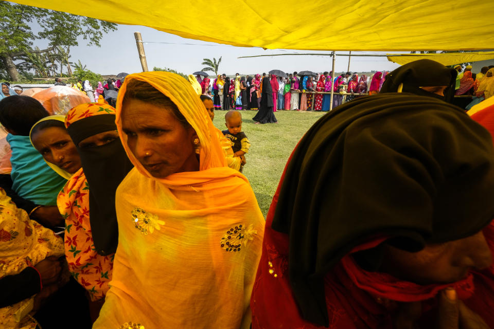 Women stand on queue to cast their votes in a polling station on the bank of the Brahmaputra river during the second round of voting in the six-week-long national election in Morigaon district, Assam, India, Friday, April 26, 2024. (AP Photo/Anupam Nath)