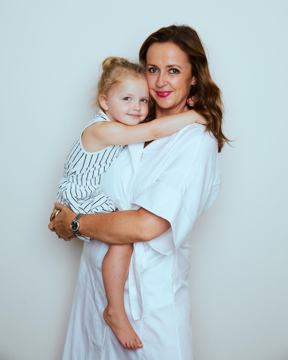 Alison Goodger and her daughter in white dresses