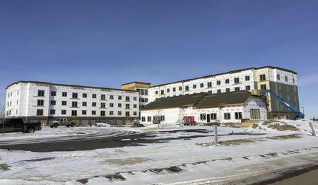 Construction continues on an apartment building in Williston, North Dakota, set to contain a swimming pool and other amenities February 27, 2015. REUTERS/Ernest Scheyder