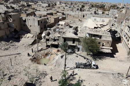 A general view shows a hole in the ground filled with water in a damaged site after airstrikes on the rebel held Tariq al-Bab neighbourhood of Aleppo, Syria September 24, 2016. REUTERS/Abdalrhman Ismail