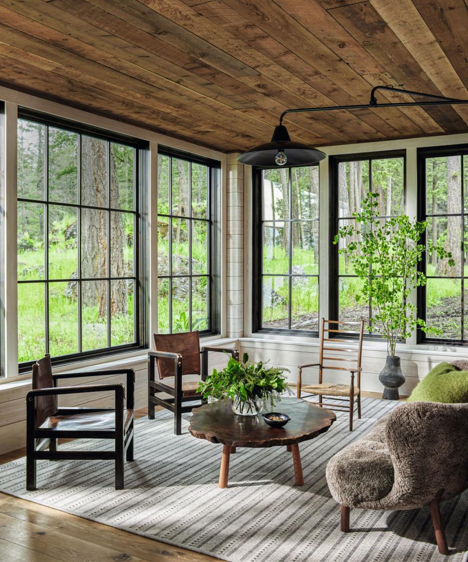 Wooden ceiling, tree coffee table, furry sofa, stripped rug