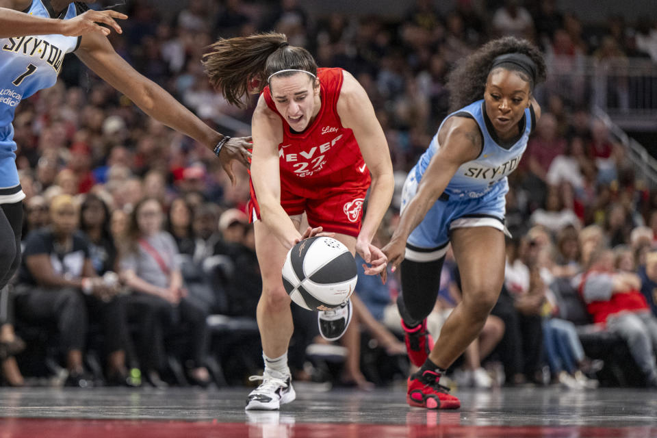 Indiana Fever guard Caitlin Clark (22) works to regain control of the ball against Chicago Sky guard Dana Evans during a WNBA basketball game Saturday, June 1, 2024, in Indianapolis. (AP Photo/Doug McSchooler)