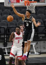 San Antonio Spurs forward Keldon Johnson (3) blocks a shot by Houston Rockets forward Jae'Sean Tate (8) during the first half of an NBA basketball game in San Antonio, Thursday, Jan. 14, 2021. (AP Photo/Eric Gay)