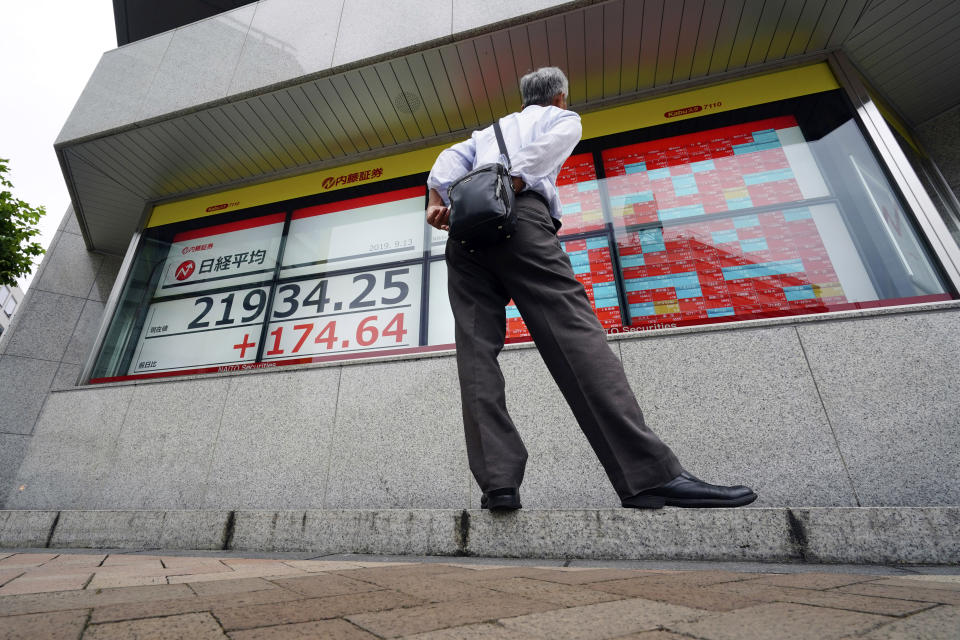 A man looks at an electronic stock board showing Japan's Nikkei 225 index at a securities firm in Tokyo Friday, Sept. 13, 2019. Stocks were broadly higher in Asia on Friday after gains overnight on Wall Street. Investors have stepped up buying on hopes for an easing of tensions in the costly trade war between the U.S. (AP Photo/Eugene Hoshiko)