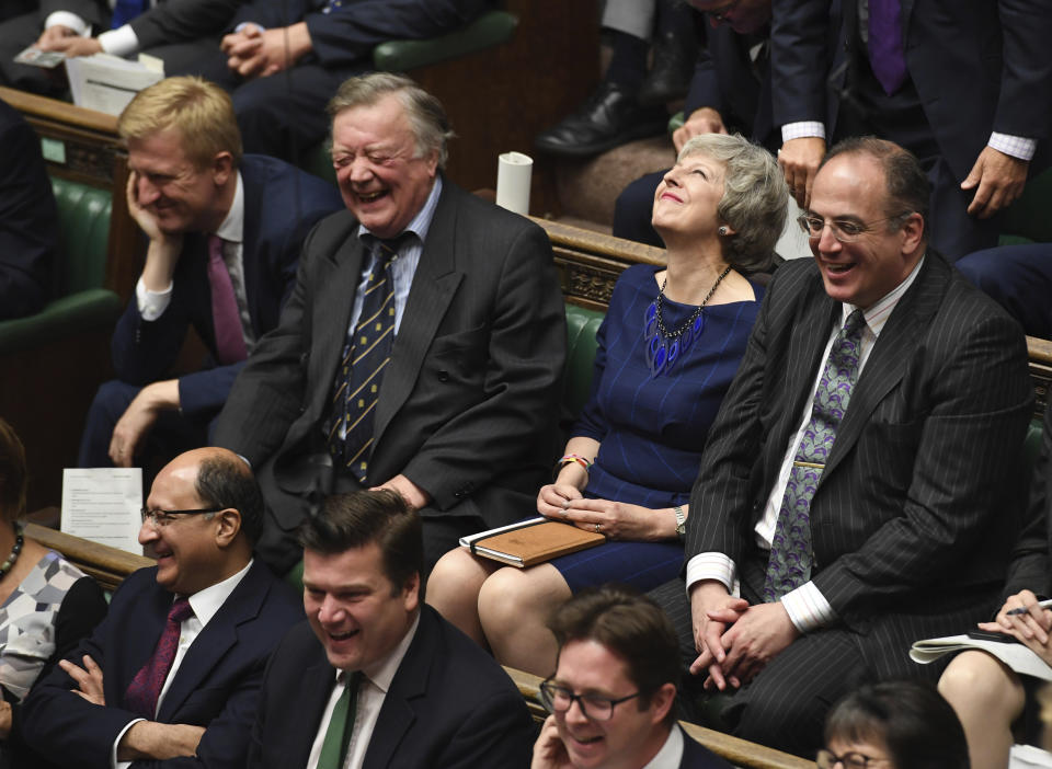 Britain's lawmakers, including Father of the House Ken Clarke, centre left, and former Prime Minister Theresa May, centre right, react during the regular Prime Minister's Question time, inside the House of Commons in London Wednesday Oct. 23, 2019. According to news reports Johnson may push for an early General Election. (Jessica Taylor / House of Commons via AP)