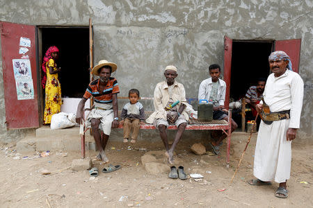 People sit outside in the village of al-Jaraib, in the northwestern province of Hajjah, Yemen February 18, 2019. REUTERS/Khaled Abdullah