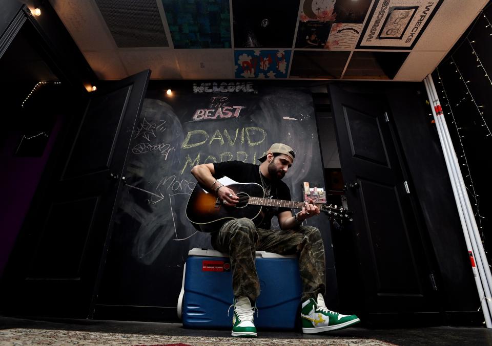 Country artist, singer songwriter and rapper David Morris plays the guitar before performing at The Basement East Friday, April 14, 2023, in Nashville, Tenn. 