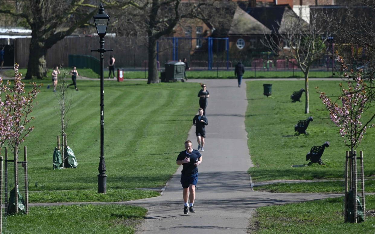 Joggers maintaining a social distance while exercising on Clapham Common, in south London - Justin Tallis/AFP
