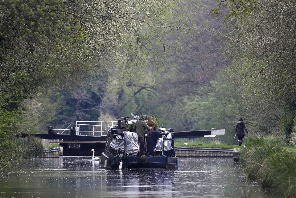 <p>A canal boat travels in the rain along the River Kennet near Theale, Berkshire. Picture date: Wednesday April 28, 2021.</p>
