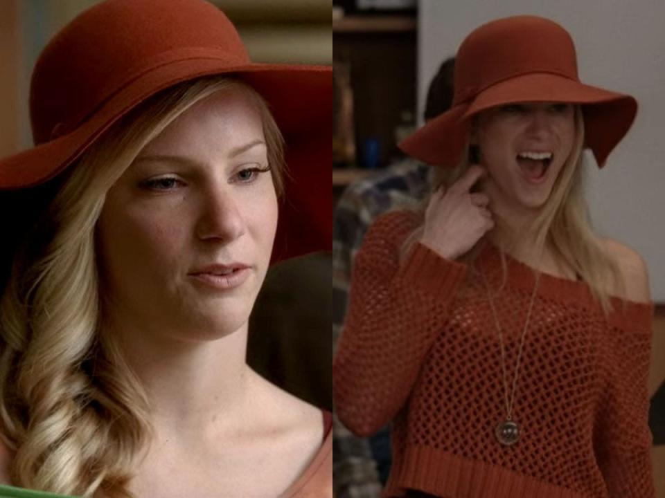 Brittany wearing an orange wide-brimmed hat.