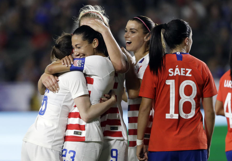 United States' Christen Press, second from left, is hugged by teammates after scoring on a penalty kick against Chile during the first half of an international friendly soccer match Friday, Aug. 31, 2018, in Carson, Calif. (AP Photo/Marcio Jose Sanchez)