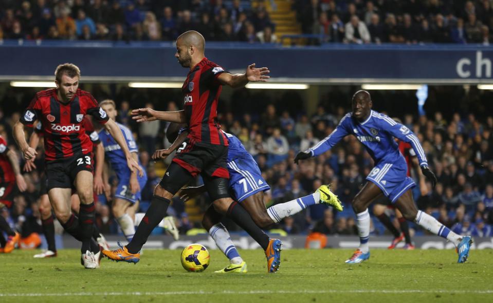 Chelsea's Ramires (C, REAR) goes to ground to win a penalty against West Bromwich Albion during their English Premier League soccer match at Stamford Bridge in London November 9, 2013.