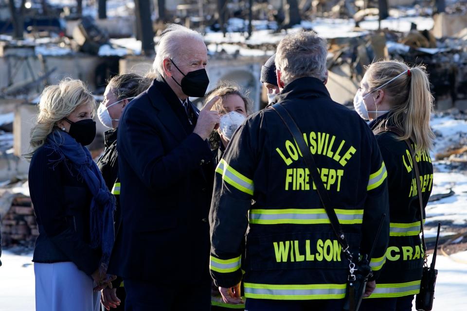 President Joe Biden and first lady Jill Biden talk with first responders as they tour a neighborhood in Louisville, Colo., on Jan. 7, 2022, that was impacted by the recent wildfire.