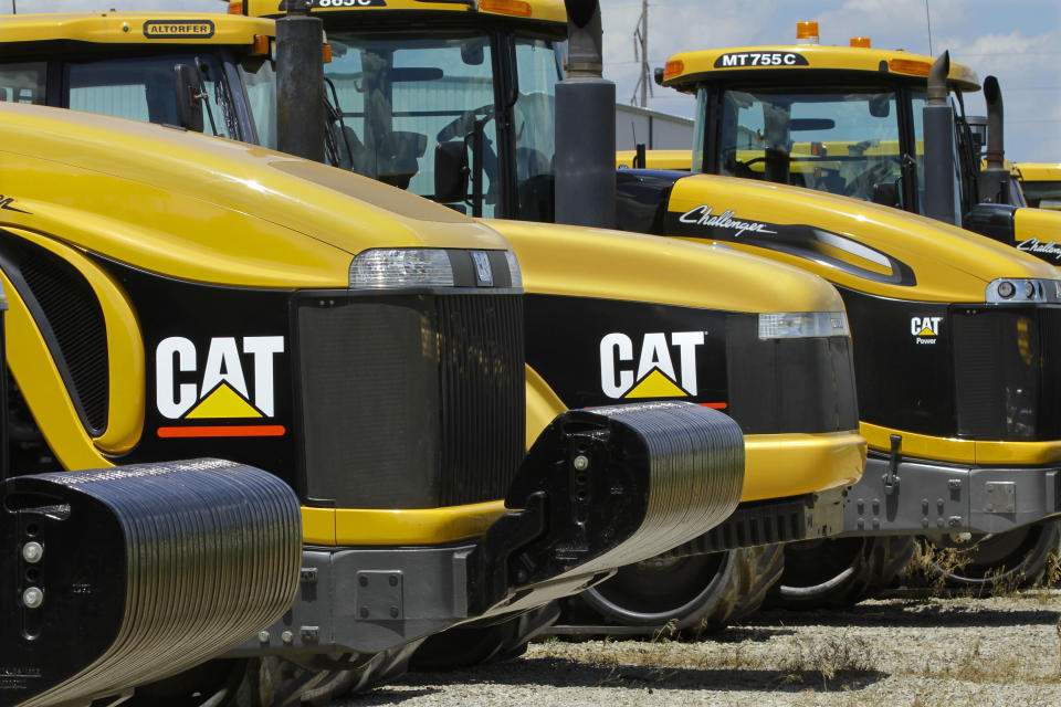 FILE - In this Wednesday, June 20, 2012, file photo, shows Caterpillar logos on earth moving tractors and equipment in Clinton, Ill. Caterpillar cut its profit and revenue guidance on Monday, Oct. 22, 2012, saying the world’s economic conditions “are weaker than we had previously expected.” Caterpillar Inc. is the world’s largest construction and mining equipment maker, so its results are watched closely as a sign of where the broader economy is headed. (AP Photo/Seth Perlman)