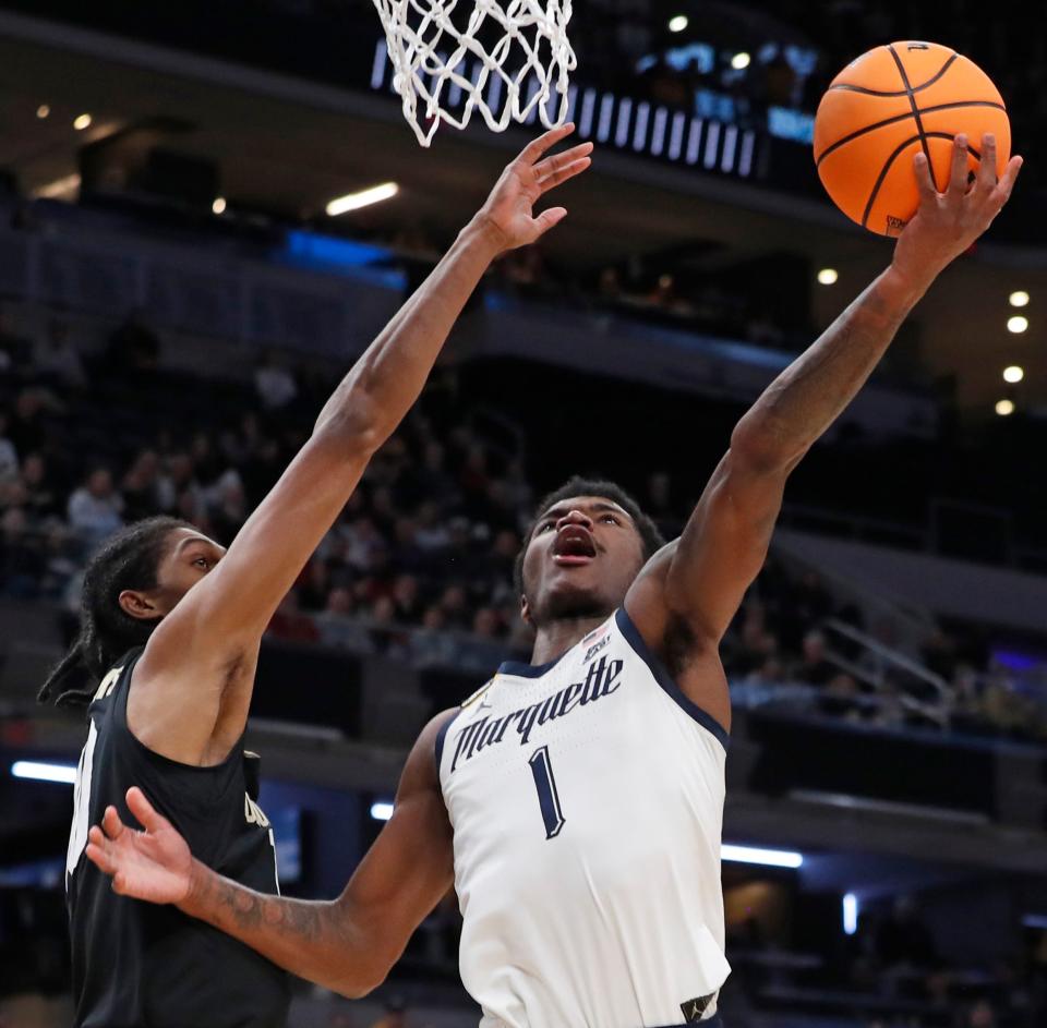 Colorado Buffaloes forward Cody Williams (10) defends the shot of Marquette Golden Eagles guard Kam Jones (1) during NCAA Menâ€™s Basketball Tournament game, Sunday, March 24, 2024, at Gainbridge Fieldhouse in Indianapolis.