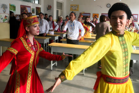 Residents at the Kashgar city vocational educational training centre dance for visiting reporters and officials in a classroom during a government organised visit in Kashgar, Xinjiang Uighur Autonomous Region, China, January 4, 2019. REUTERS/Ben Blanchard