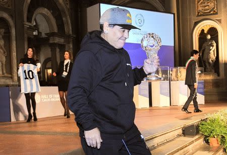 Argentinian soccer legend Diego Armando Maradona holds the prize received during the Italian soccer Hall of Fame 2017 event in Florence, Italy, January 17, 2017. REUTERS/Paolo Lo Debole