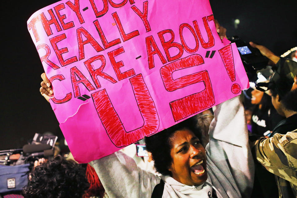 Demonstrators protest in front of the police station on March 12, 2015 in Ferguson, Missouri. Two police officers were shot yesterday while standing outside the station observing a similar protest. Ferguson has faced many violent protests since the August shooting death of Michael Brown by a Ferguson police officer. 