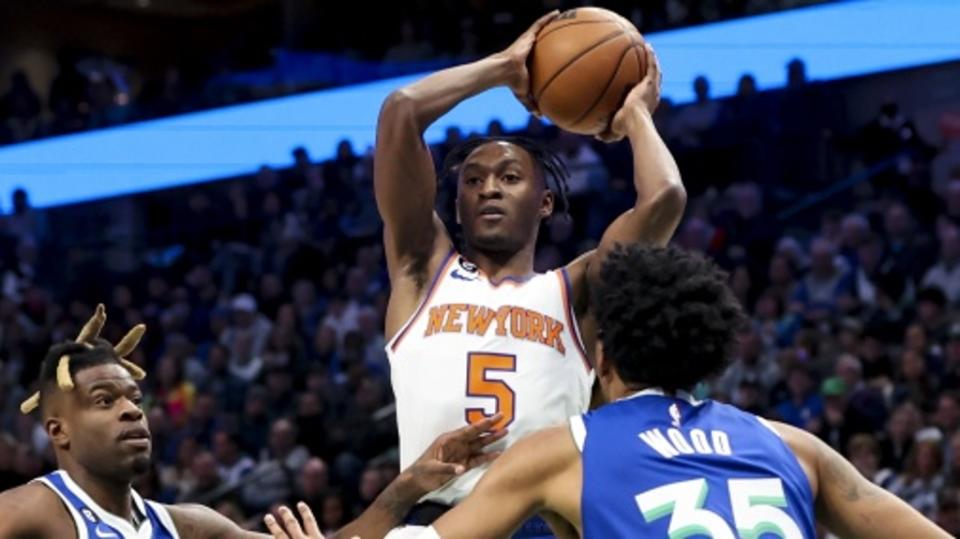 Dec 27, 2022; Dallas, Texas, USA; New York Knicks guard Immanuel Quickley (5) looks to pass over Dallas Mavericks forward Christian Wood (35) and Dallas Mavericks forward Reggie Bullock (25) during the first quarter at American Airlines Center