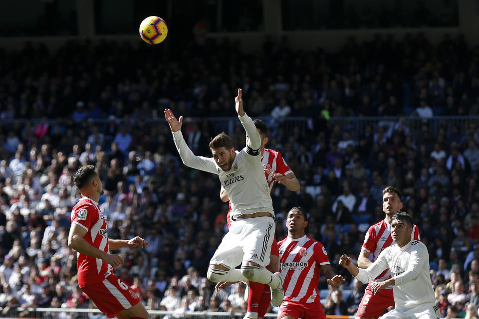 Real Madrid's Sergio Ramos, center, gestures after heading the ball during a La Liga soccer match between Real Madrid and Girona at the Bernabeu stadium in Madrid, Spain, Sunday, Feb. 17, 2019. (AP Photo/Andrea Comas)