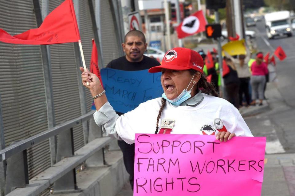 Farmworker Lourdes Cardenas marches across Highway 99 on Fresno Street, as she leads the march on Cesar Chavez Day, March 31, 2022, to urge Gov. Gavin Newsom to sign the Ag Labor Voting Choice Act, providing more choices in how farm workers can vote in their union elections.