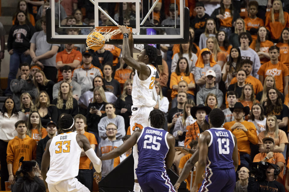 Oklahoma State's Kalib Boone, center top, slam-dunks during the second half of an NCAA college basketball game against TCU in Stillwater, Okla., Saturday, Feb. 4, 2023. (AP Photo/Mitch Alcala)