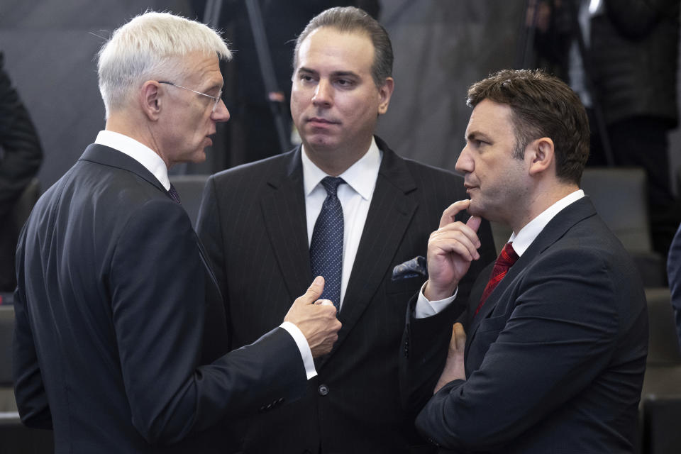 Latvian Foreign Minister Krisjanis Karins, left, speaks with Minister of Foreign Affairs of Montenegro Filip Ivanovic, center, and Minister of Foreign Affairs of the Republic of North Macedonia Bujar Osmani, prior to the start of the NATO Foreign ministers meeting in Brussels, Belgium, Tuesday, Nov. 28, 2023. (Saul Loeb/Pool Photo via AP)