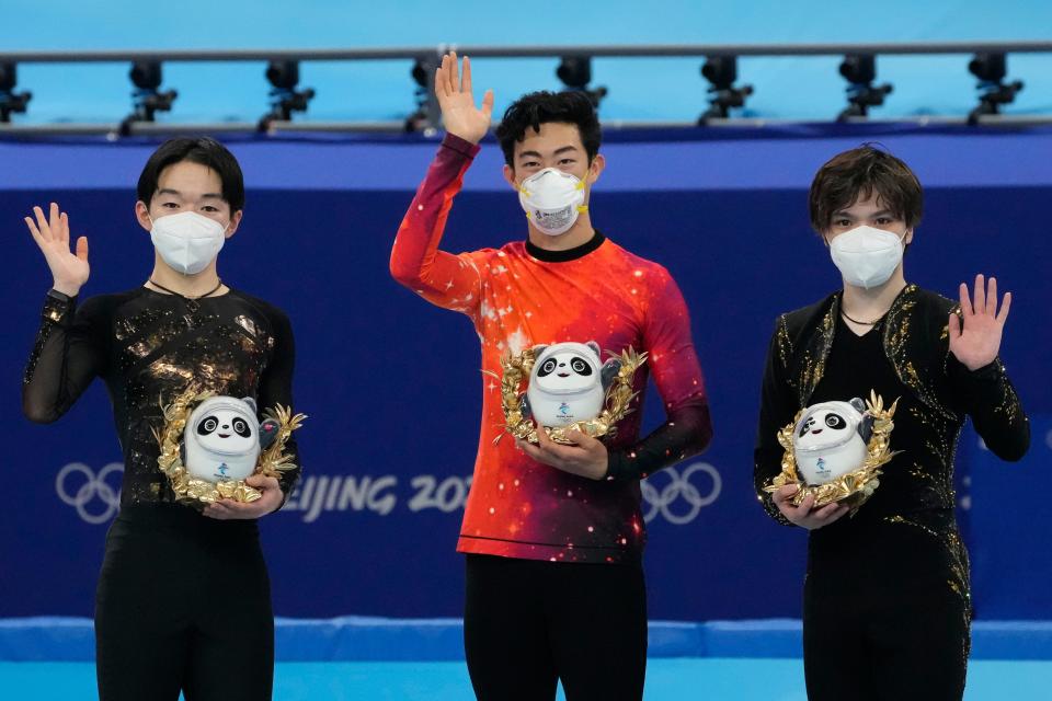 Silver medalist Yuma Kagiyama (JPN) and gold medalist Nathan Chen (USA) and bronze medalist Shoma Uno (JPN) react on the medal platform after the mens singles free program during the Beijing 2022 Olympic Winter Games at Capital Indoor Stadium on Feb 10, 2022.