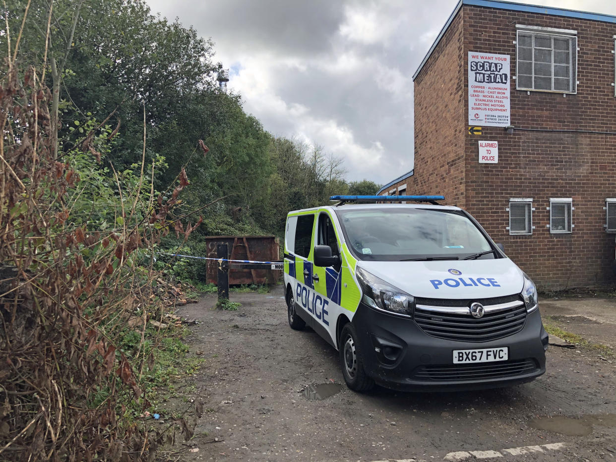 A police vehicle outside where West Midlands Police have cordoned off a pathway alongside industrial units Industrial Estate in Brierley Hill, West Midlands, in the area where two men were found shot dead in a car on Wednesday afternoon.