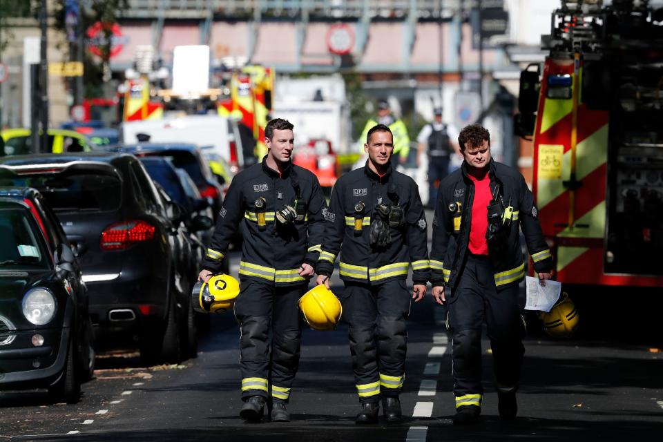 Members of the London Fire Brigade emergency service work near Parsons Green.