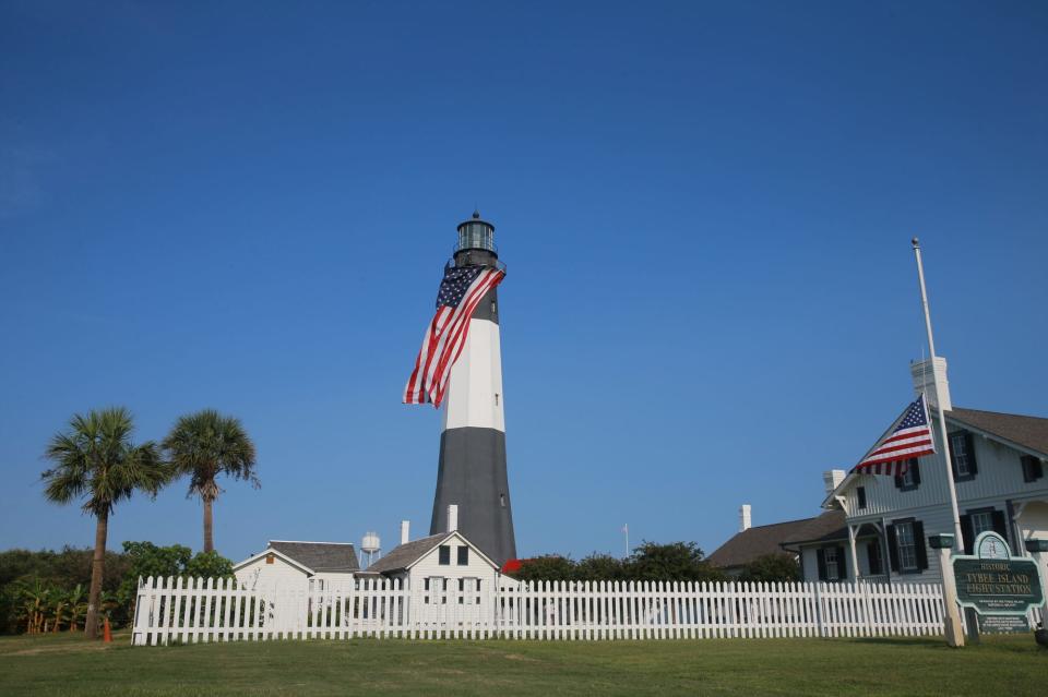 Old Glory waves in the ocean breeze as a bagpiper plays from the top of the Tybee Island Lighthouse Saturday morning during a special ceremony commemorating the 20th anniversary of 9/11.