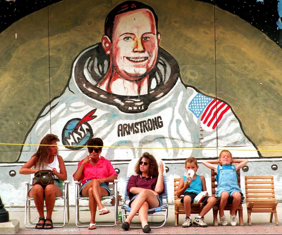 Pam Krites, Shirley Meiring, Mary Meiring, Cory Krites, 7, and Erica Molineaux, 9, from left, stake out their spots for a parade Saturday, July 9, 1994, in Wapakoneta, Ohio, to mark the 25th anniversary of Neil Armstrong's walk on the moon.