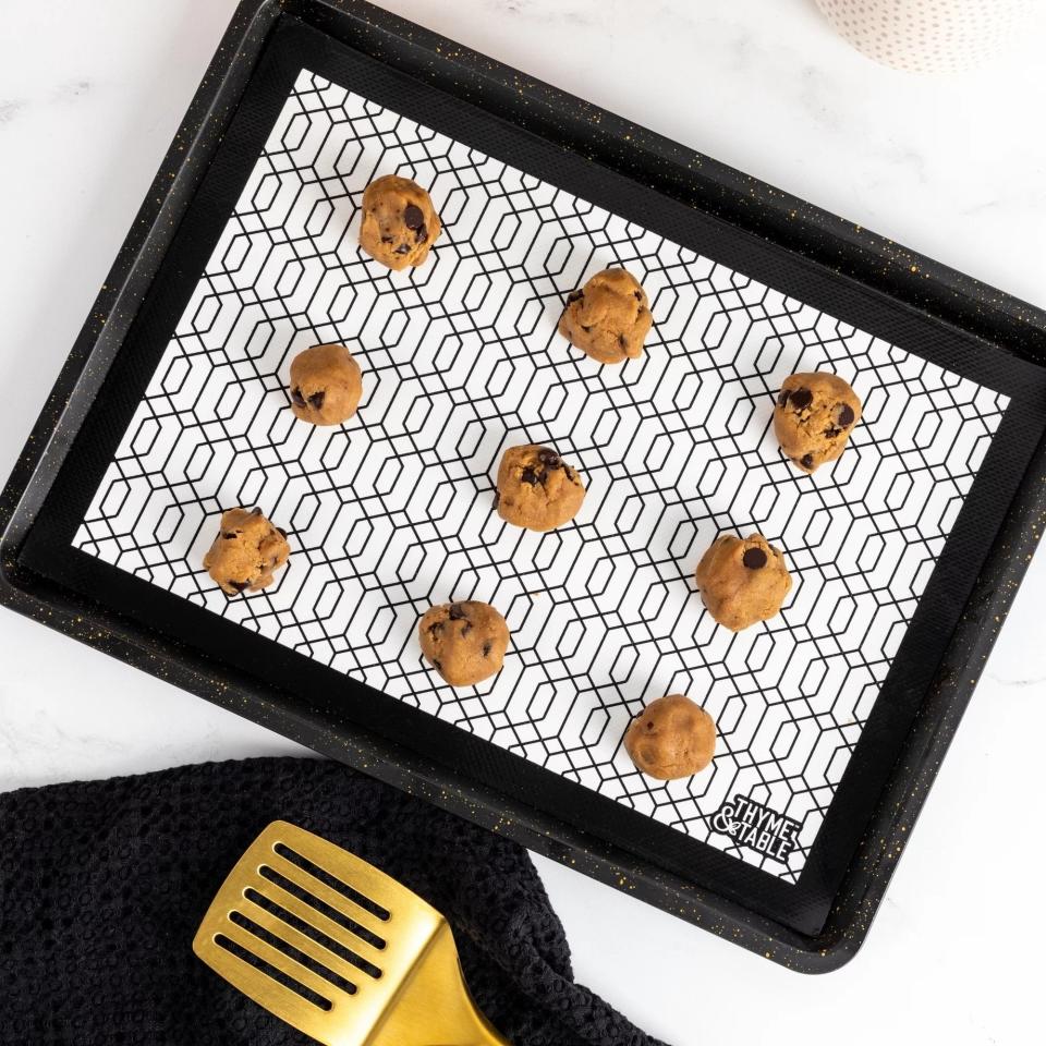 cookie dough placed on the baking mat, which features a geometric design in black and white