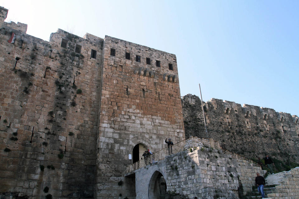 FILE - In this March 21, 2014 file photo, Syrian troops stand by the Crac des Chevaliers as they take reporters on a tour a day after Syrian troops ousted rebels from the castle located near the village of Hosn, Syria. The fall of much of the rebel-held areas near the border with Lebanon recently show that President Bashar Assad is not only still standing, but that he is winning on the battlefield and preparing the ground for his re-election for another seven-year presidential term. (AP Photo, File)