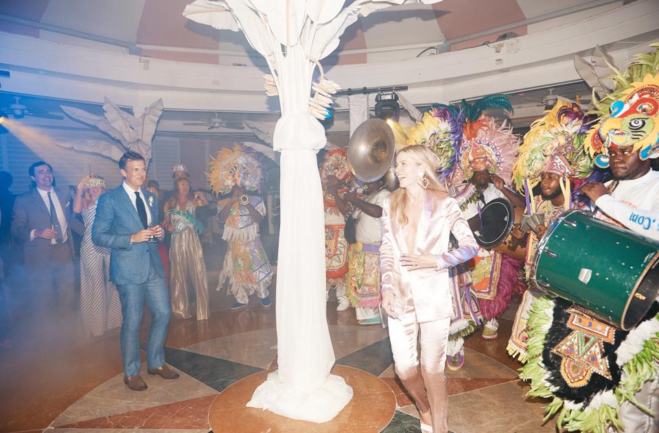 Our first dance—if you can call it that—was during the Junkanoo performance. I changed into an Amur suit and Alessandra Rich heart earrings. Adrian declined the opportunity for an outfit change.