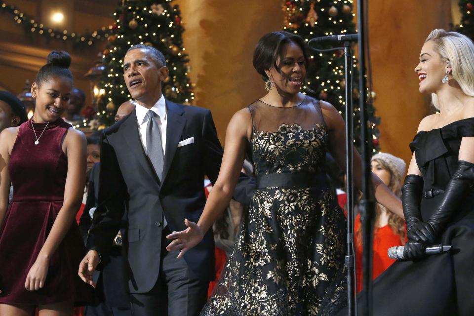 U.S. President Barack Obama, standing onstage with first lady Michelle Obama, their daughter Sasha and singer Rita Ora, participates in the taping of the 'Christmas in Washington' in Washington