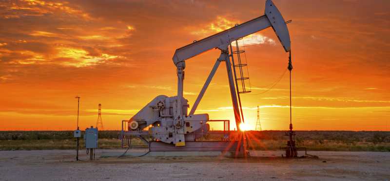 An oil pump amid a Texas sunrise.