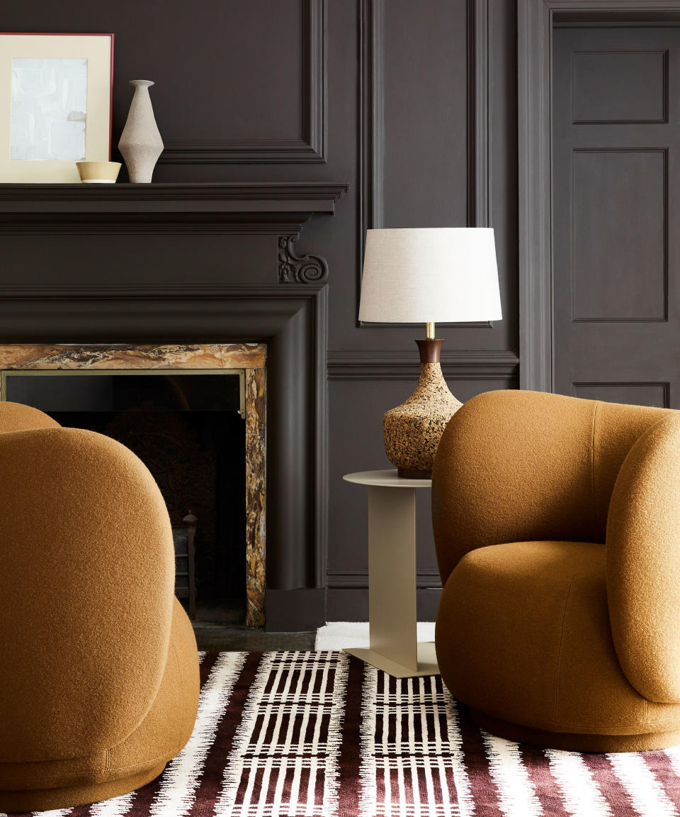 Gray living room with ochre colored seating and striped rug